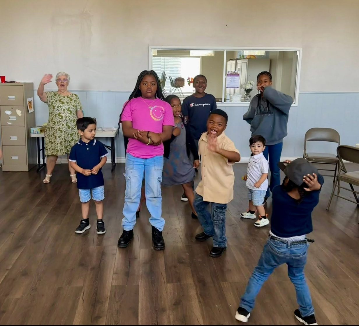 Children singing and waving at Children's Church